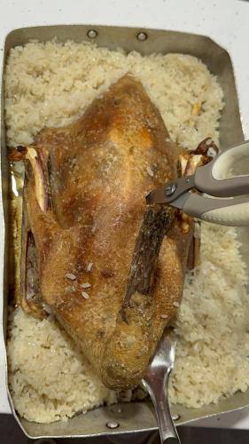 a piece of chicken in a pan with rice at VILA DISHA in Tirana