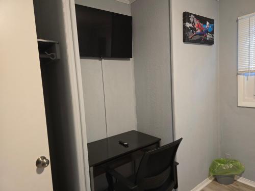 a room with a desk and a chair in a room at Cozy Haven in Hampton Roads Near Beaches, Military Bases & Historic Sites in Hampton