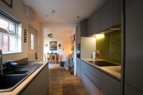 a kitchen with a sink and a counter top at Vibrant 2 Bed, 2 Bath Home, Just Minutes to Town! in Ross on Wye