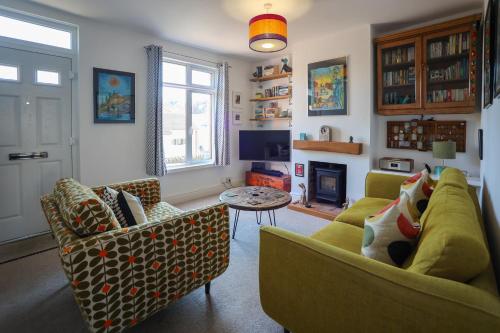 a living room with two couches and a table at Vibrant 2 Bed, 2 Bath Home, Just Minutes to Town! in Ross on Wye