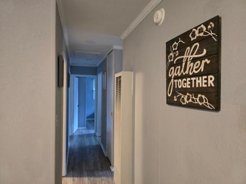 a hallway with a sign that reads all volunteer together at Cozy Haven in Hampton Roads Near Beaches, Military Bases & Historic Sites in Hampton