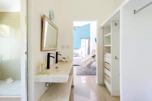 a bathroom with a sink and a mirror at Lux 4BR Playacar Villa with Pool in Playa del Carmen