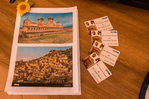 a table with some cards and a book and a magazine at Casa vacanza da Giuseppe in Leonforte