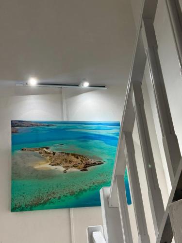 a painting of a island on a wall in a room at Villa Océan Gravier Rodrigues in Mt Bois Noir
