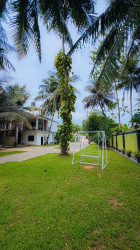 a soccer goal in a field with palm trees at Hotel Milenium in Kurundankulama