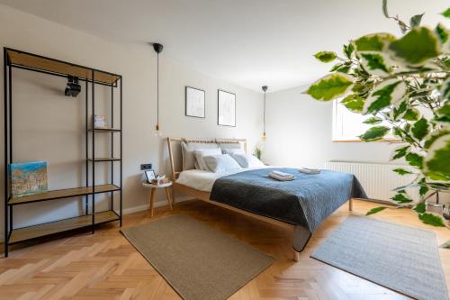 a bedroom with a bed and a potted plant at Budapest Central Sky Spa Penthouse in Budapest