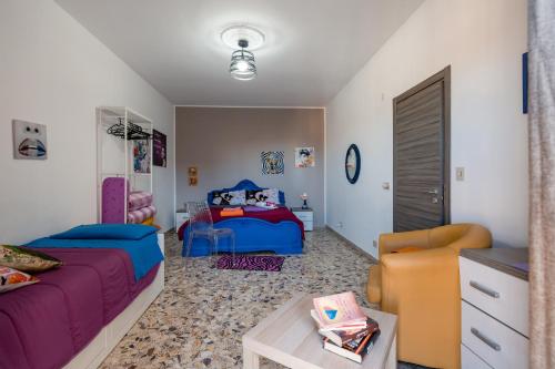 a bedroom with a bed and a couch and a table at Casa vacanza da Giuseppe in Leonforte