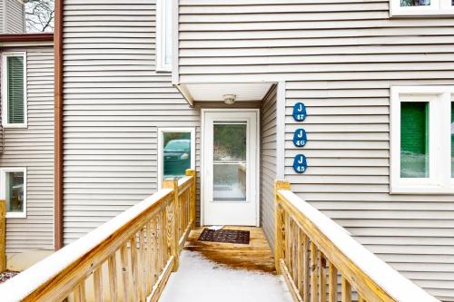 a house with a white door and a wooden porch at Briarcliff J47 in Sugar Mountain