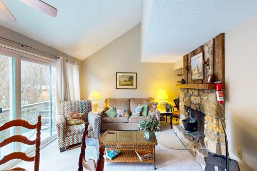 a living room with a couch and a fireplace at Briarcliff J47 in Sugar Mountain