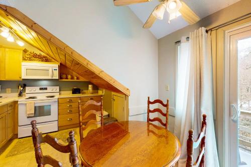 a kitchen with a wooden table and a dining room at Briarcliff J47 in Sugar Mountain