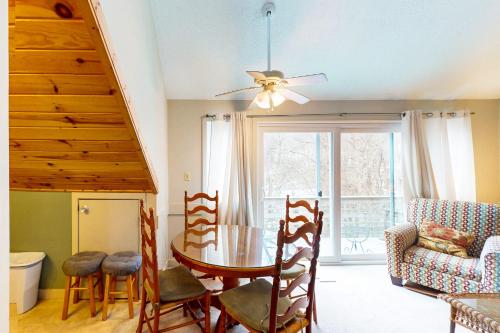 a dining room with a table and chairs and a window at Briarcliff J47 in Sugar Mountain