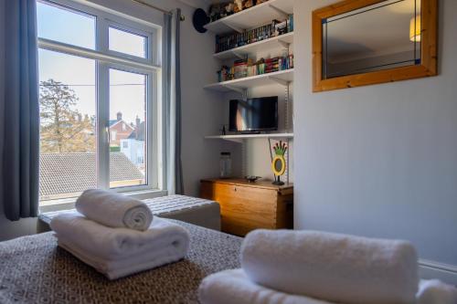 a living room with a large window and a couch at Vibrant 2 Bed, 2 Bath Home, Just Minutes to Town! in Ross on Wye