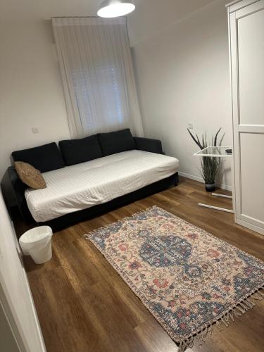 a couch in a living room with a rug at דירת בוטיק Dnine7 in Haifa