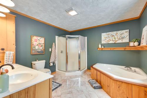 a bathroom with a shower and a tub and a sink at Fish, Hike and Ski Spacious Family Escape in Eden in Eden