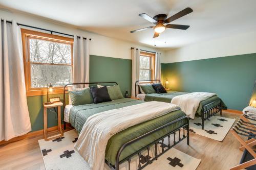 two beds in a room with green walls at Fish, Hike and Ski Spacious Family Escape in Eden in Eden