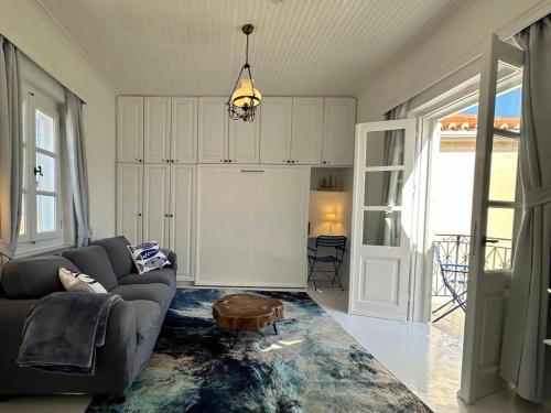 a living room with a couch and a table at Louisa’s View in Hydra
