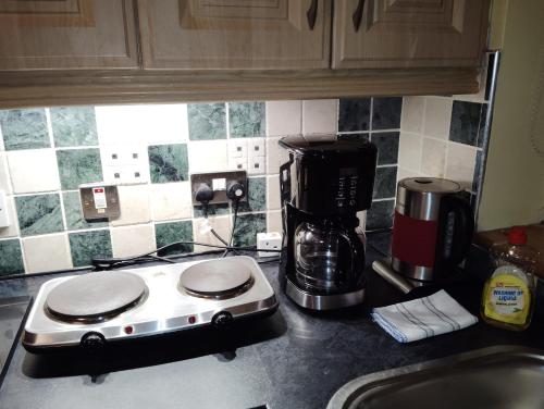 a kitchen counter with a toaster and a coffee maker at Welcome to Tunmobi Villa, its home away from home. in Ballyjamesduff