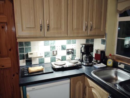 a kitchen with a sink and a counter top at Welcome to Tunmobi Villa, its home away from home. in Ballyjamesduff