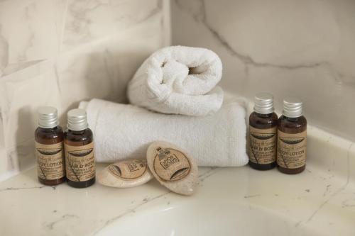 a bathroom with a towel and two bottles of essential oils at Pension Tui in Sinaia