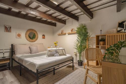 a bedroom with a bed in a room with plants at Old San Juan Apartment in San Juan