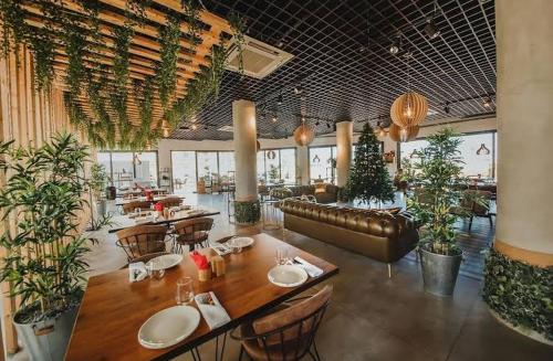 a restaurant with a table and chairs and plants at Уютные апартаменты -cozy apartments in Bahçeler