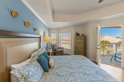 a bedroom with a bed and a balcony at Villas of Ocean Gate II 306 in Butler Beach