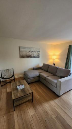 a living room with a couch and a table at ENTIRE 2 BEDROOM APARTMENT by UW RESEARCH PARK - PS5 in Waterloo