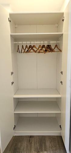 a walk in closet with white shelves at Vacansis Masamagrell Bajo Loft Tomas y Valiente in Masamagrell