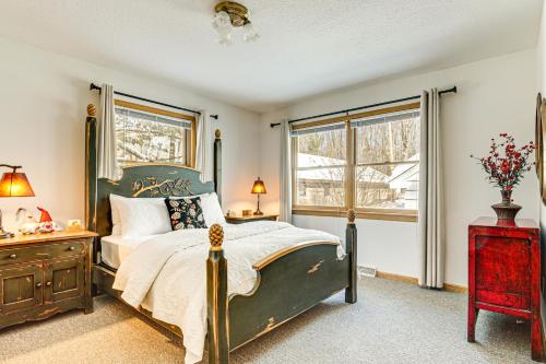 a bedroom with a bed and a dresser and a window at Lakefront Home with Private Beach in Rhinelander! in Rhinelander