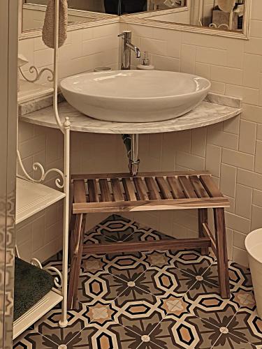 a bathroom with a sink and a mirror at La Funambola BB in Poggio Alla Croce