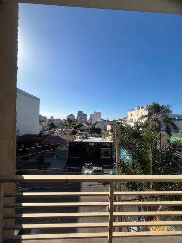 a balcony with a fence and a train on it at Luminoso monoambiente in San Justo