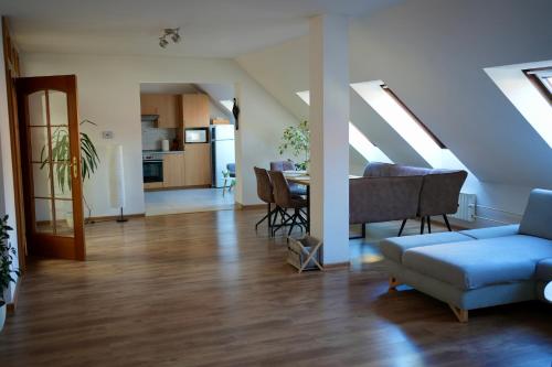 a living room with a couch and a dining room at Ubytování U Pivovaru in Kamenice nad Lipou