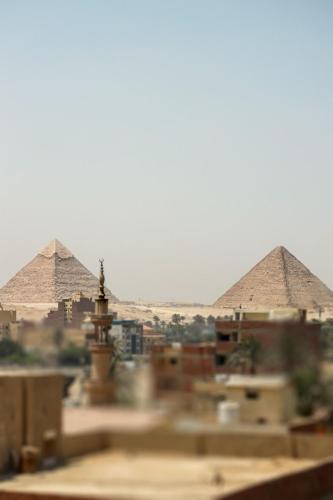 a view of the pyramids of giza from a city at La Veranda Pyramids Boutique Hotel in Cairo