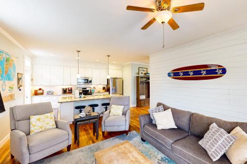 a living room with a couch and chairs and a kitchen at Knot a Care in Lincoln City