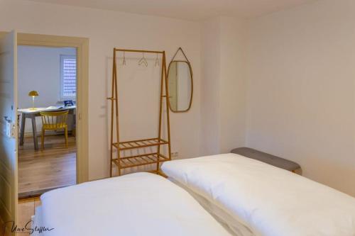 two beds in a room with a mirror and a ladder at Ferienhaus Honey Bee in Billingsbach
