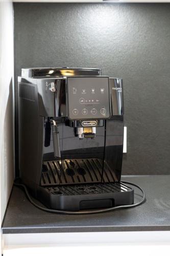 a black coffee maker sitting on top of a counter at Ferienhaus Gersmühle in Satteldorf