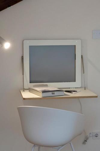 a computer monitor sitting on top of a desk at Ferienhaus Gersmühle in Satteldorf