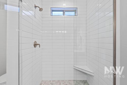 a white bathroom with a shower with a window at RSD 3041 in Coeur d'Alene