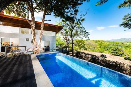 a swimming pool in the backyard of a house at Hammock House Your Private Oasis Near Tamarindo in Villarreal