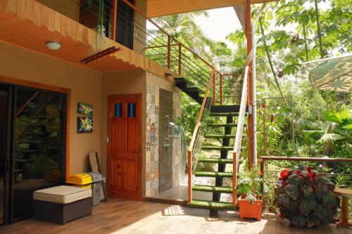 a staircase leading up to a house with a patio at Eco Villas-Houses-Tents Corcovado-Mountain-Ocean Views in Puerto Jiménez