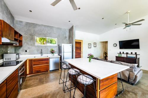 a kitchen and living room with a large island in the middle at Hammock House Your Private Oasis Near Tamarindo in Villarreal