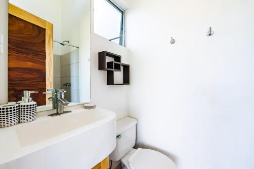 a bathroom with a white sink and a toilet at Hammock House Your Private Oasis Near Tamarindo in Villarreal
