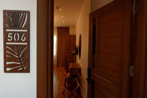 a hallway with a wooden door and a room at La Veranda Pyramids Boutique Hotel in Cairo