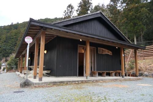 a black building with a stop sign in front of it at Camping-style accommodation: Yumeraku - Vacation STAY 65716v in Ema