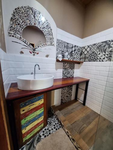 a bathroom with a sink and a mirror at Eco Villas-Houses-Tents Corcovado-Mountain-Ocean Views in Puerto Jiménez