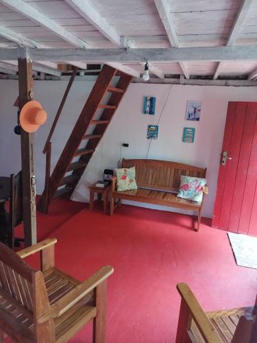 a living room with a couch and a red carpet at Casa Anahata in Algodoal