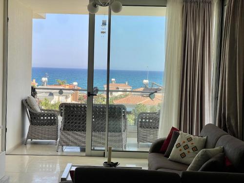 a living room with a view of the ocean at Sea Breeze Suite by the Sea in Vokolidha