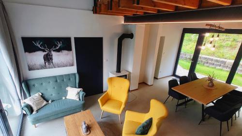 a living room with a table and a dining room at Cha-lu-pa in Šumperk