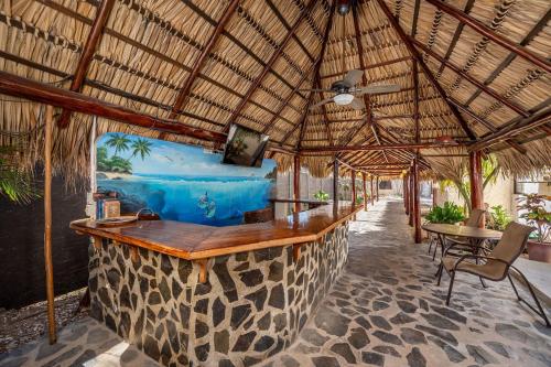 a bar in a resort with a view of the ocean at BP surf hotel in Refundores
