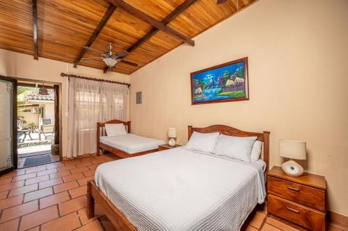 a bedroom with a bed and a chair in it at BP surf hotel in Refundores